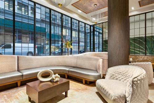 a lobby with a couch and a chair and a table at Hyatt Centric Midtown 5th Avenue New York in New York