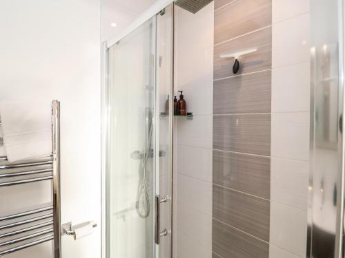 a shower with a glass door in a bathroom at Ebenezer Chapel in Saxmundham