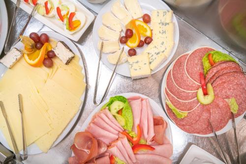 a bunch of different types of food on plates at Hotel Hochseeinsel in Helgoland