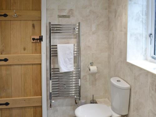 a bathroom with a toilet and a towel rack at Tresidder Barn in Constantine