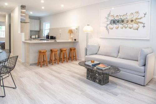 a living room with a couch and a table at Luxury modern CBD ground floor apartment. in Canberra