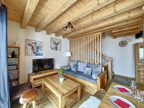 a living room with a couch and a table at Chalet Le Gebroulaz in La Toussuire