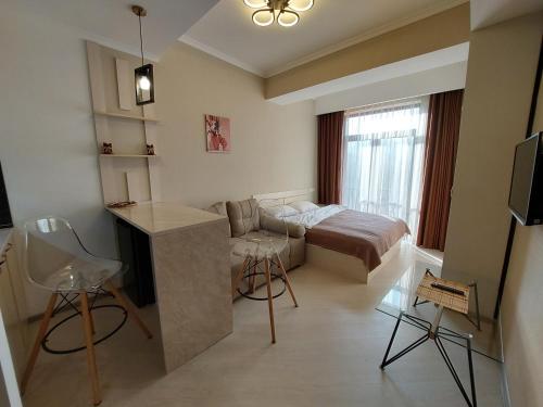 a small room with a bed and a kitchen in it at Tsaghkadzor, Alvina Complex Apartment 163 in Tsaghkadzor