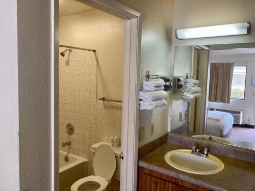 a bathroom with a sink and a toilet and a mirror at Premier Inns Concord in Concord