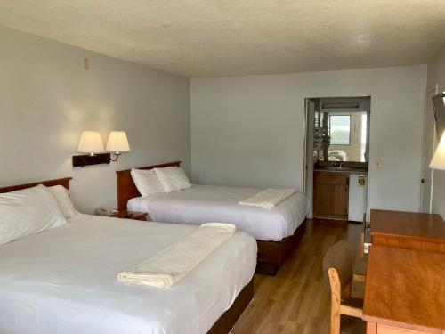 a hotel room with two beds and a window at Premier Inns Concord in Concord