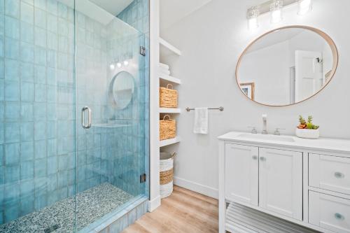 a bathroom with a glass shower and a sink at Moonlight Cove in Encinitas