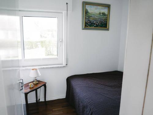 a bedroom with a bed and a window at Gemütliches Ferienhäuschen an der Schlei & Ostsee in Maasholm