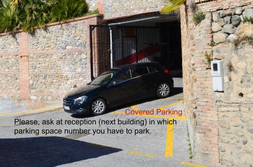 a small car parked in a parking garage at Hotel Santa Isabel La Real in Granada