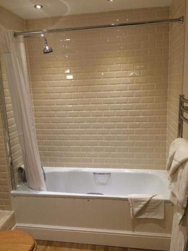 a bathroom with a bath tub in a room at Trearddur Bay Hotel in Trearddur