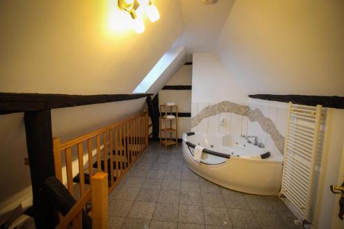 a bathroom with a large tub in a room at Hotel und Restaurant Zum Löwen in Gelnhausen