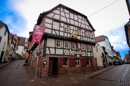 a black and white building on a city street at Hotel und Restaurant Zum Löwen in Gelnhausen
