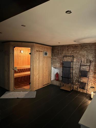 a room with a wooden door and a brick wall at Loft mit privater Sauna in Heidelberg