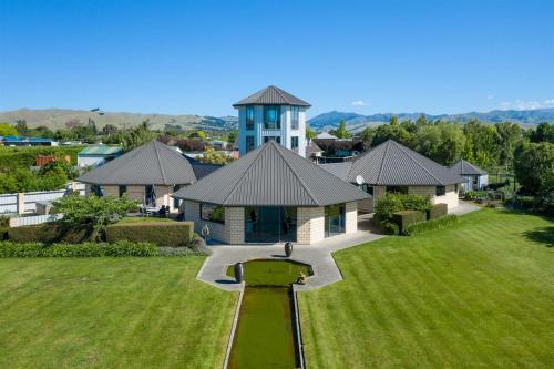 an aerial view of a house with a pond in a yard at Battys Road Lodge in Blenheim