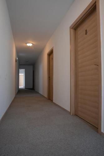 an empty hallway with a door in a building at Restoran Mijajlovic in Kuršumlija