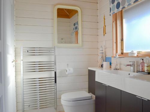 a bathroom with a toilet and a sink at Quarry Lodge in Little Marcle