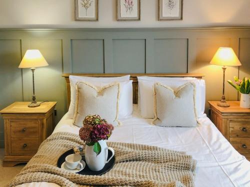 a bedroom with a white bed with flowers on it at Maes Y Bryn Farmhouse in Llanwrda