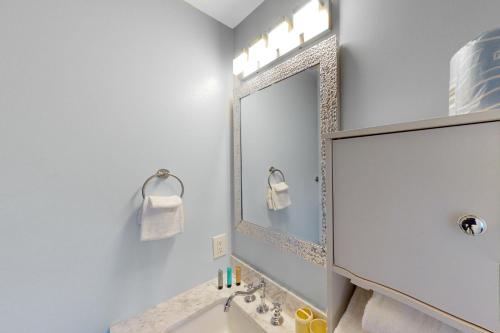 a white bathroom with a sink and a mirror at Summer Lake Townhomes 1 in Destin