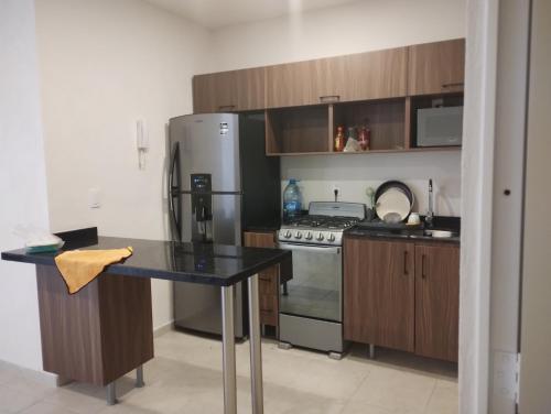 a kitchen with a stainless steel refrigerator and a counter at Torres casillas in Tonalá