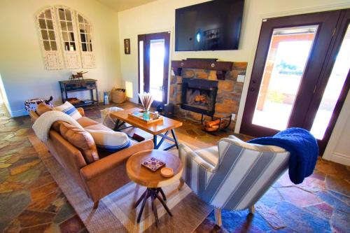 a living room with a couch and a fireplace at Peppertree Lane Ranch -- Seven-Acre Ranch in the Heart of Wine Country in Temecula
