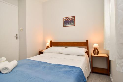 1 dormitorio con 1 cama azul y blanca y 2 lámparas en Meia quadra da Praia nos Ingleses, 4 hóspedes P2057, en Florianópolis