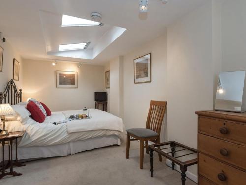 a bedroom with a bed and a television in it at Little Trout in Middle Wallop