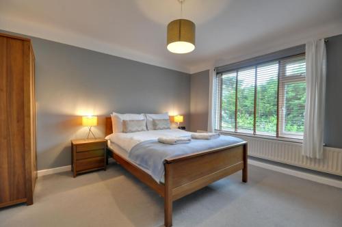 a bedroom with a bed and a large window at Mauve in Poole