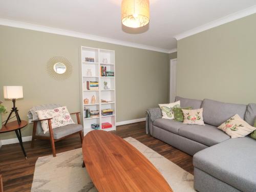a living room with a couch and a table at Castle View Annex in Wareham