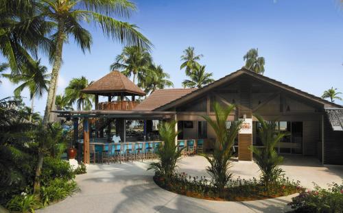 a resort with a gazebo and palm trees at Shangri-La Golden Sands, Penang in Batu Ferringhi