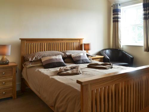 a bedroom with a large bed with two towels on it at Durham Cottage-27765 in Wolsingham