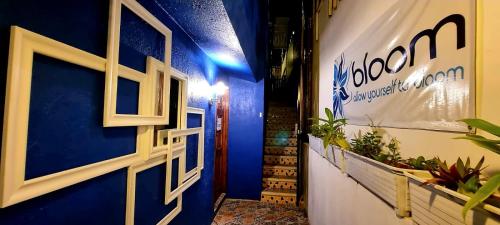 a hallway with a blue wall and a door at Bloom! exclusive boutique b&b in Playa del Carmen