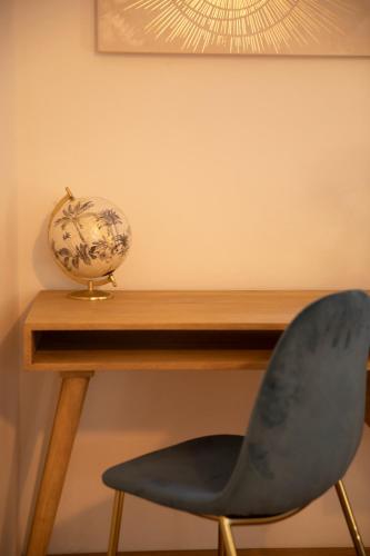 a desk with a chair and a vase on it at Cuore di Relais e Châteaux 5 STELLE in Bellinzona CITY OF CASTLES -By EasyLife Swiss in Bellinzona