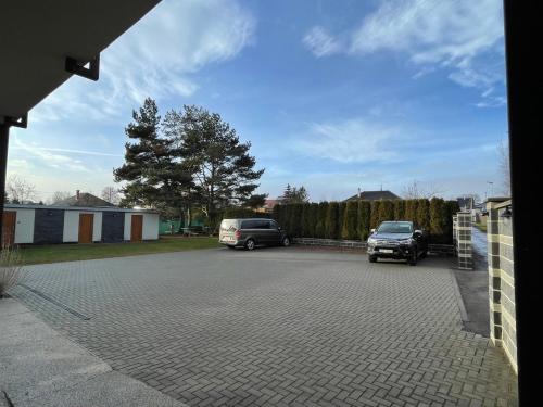 two cars are parked in a parking lot at Penzion Klasa - Slezská Harta in Leskovec nad Moravicí