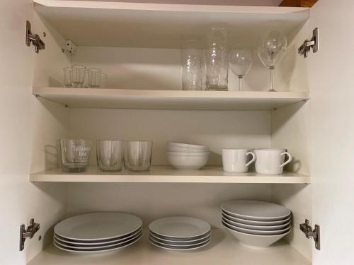 a pantry with plates and glasses on shelves at Penzion Klasa - Slezská Harta in Leskovec nad Moravicí