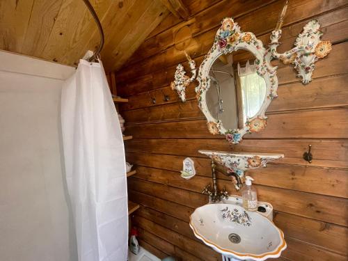 W łazience znajduje się umywalka i lustro. w obiekcie 7eme ciel - Tiny House avec Grande Piscine intérieure chauffée toute l'année w mieście Marais-Vernier