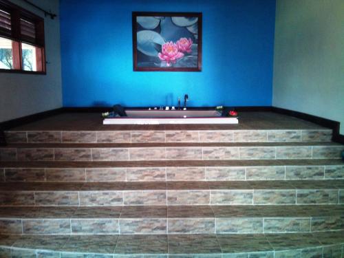 a bathroom with a tub on top of some stairs at Serenity on the Lake in Kalemera