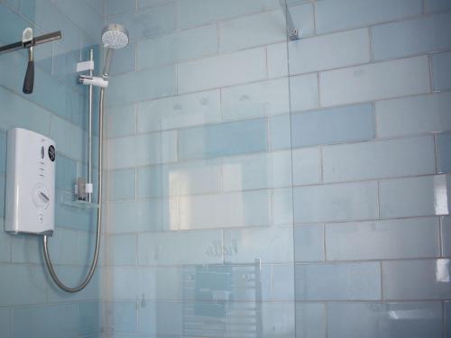 a shower in a bathroom with a glass wall at Guillemots in Littlehampton