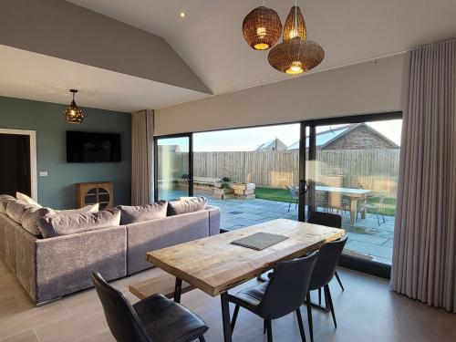 a living room with a couch and a table at Bailgate Barn, Ashlin Farm Barns in Lincoln