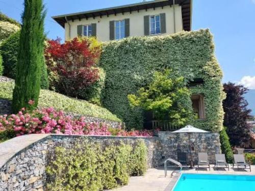 a house with a swimming pool in front of it at Casa Santo Stefano in Cernobbio