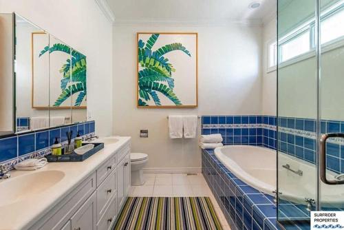 a bathroom with a tub and a sink and a toilet at Malibu Road Beachfront Charmer in Malibu