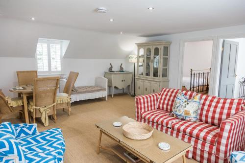 a living room with two couches and a table at The Coach House in Lincolnshire