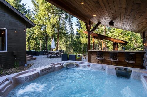 a hot tub in the backyard of a house at Riffle River Lodge by NW Comfy Cabins in Leavenworth