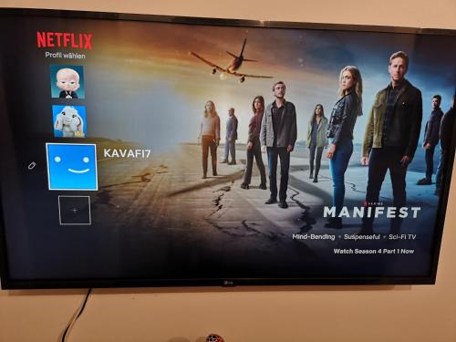 a flat screen tv hanging on a wall at Serres Kavafi 7 city center , FREE PARKING , FREE NETFLIX in Serres