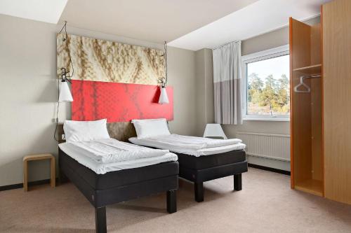 a room with two beds and a window at Sure Hotel by Best Western Spånga in Stockholm