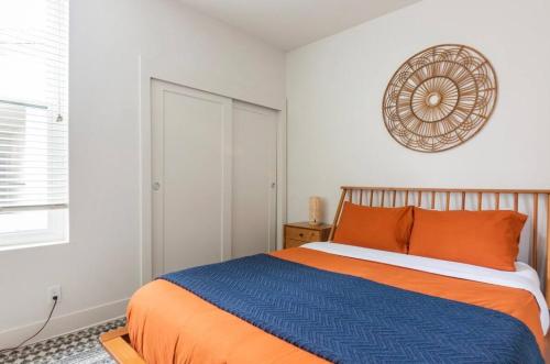 a bedroom with a bed with orange and blue sheets at Tulum Vibes 1 Bedroom Apartment near Boats in Marina Del Rey in Los Angeles