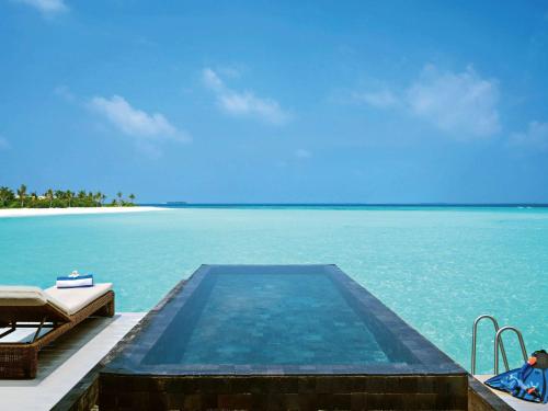 a swimming pool in the middle of the ocean at Mӧvenpick Resort Kuredhivaru Maldives in Manadhoo