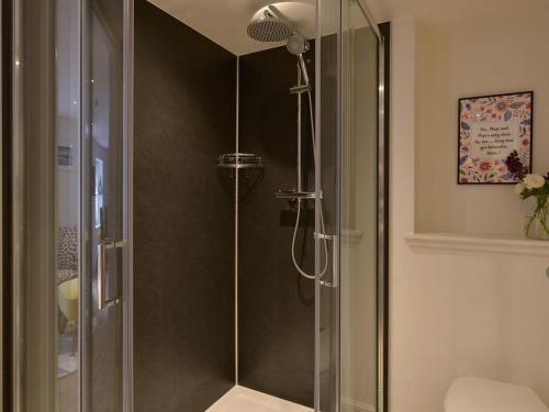 a shower with a glass door in a bathroom at Bonnie Cottage - Uk40057 in Aberfeldy