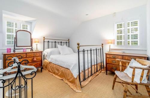 a bedroom with a bed and a dresser and a mirror at The Coach House in Lincolnshire