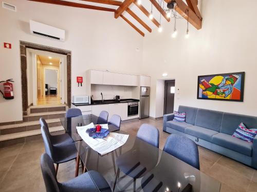 a living room with a couch and a table and chairs at Quinta da Abadia in Mangualde