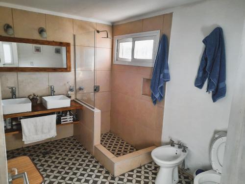 a bathroom with a sink and a toilet at Starry Lodge in Ciudad Lujan de Cuyo