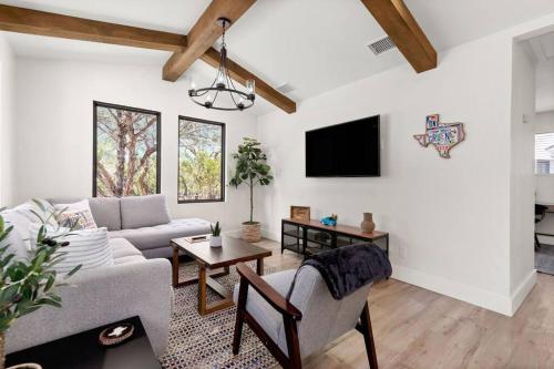 a living room with a couch and a table at Casita 5 minutes from Gruene Hall and King Bed! in New Braunfels